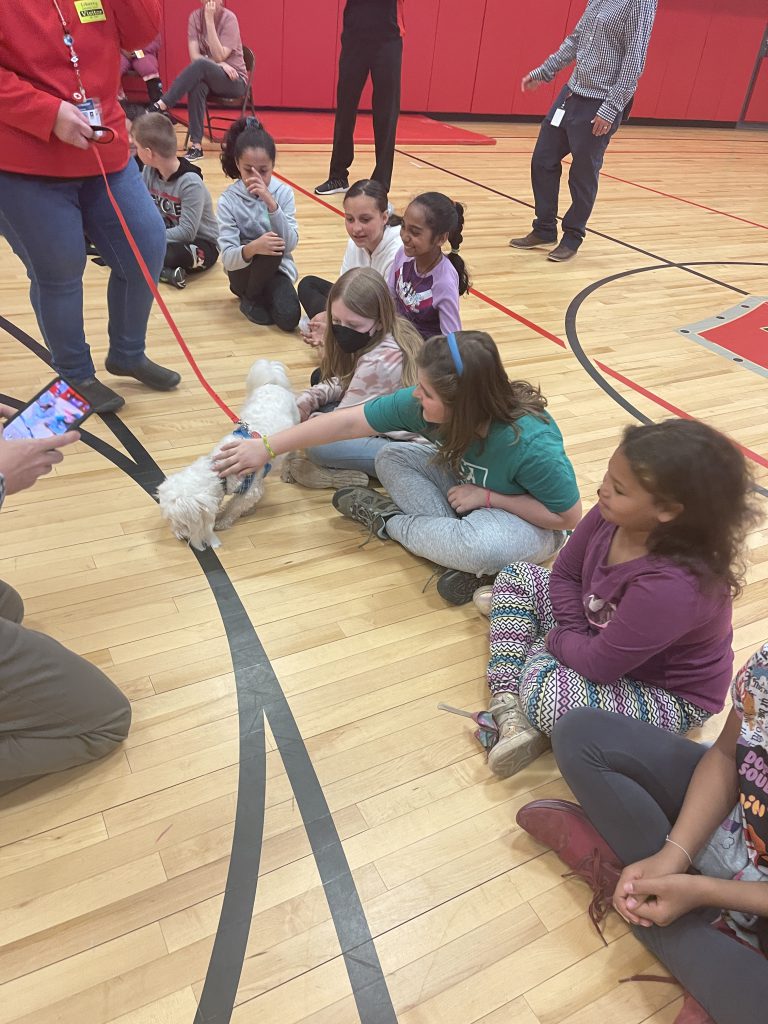 Children pet a therapy dog
