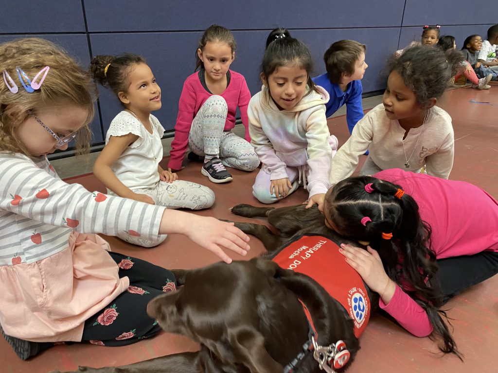 children pet a therapy dog