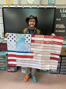 A man displays a paper flag