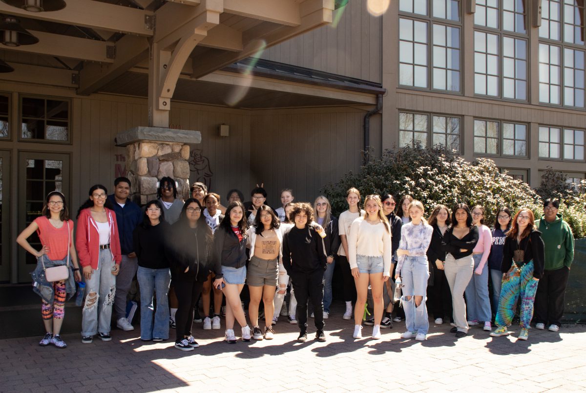Students line up for a photo in front of Bethel Woods