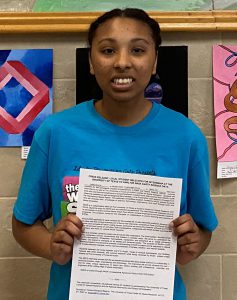 A students holds a media release about her entering an internship program