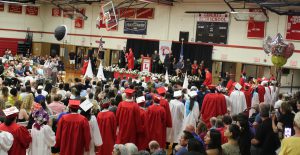 Students lineup in the aisle ready to cross the stage to get their diplomas