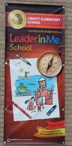 A sign promoting Leader in Me at Liberty Elementary