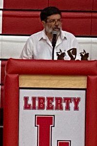 Ralph Bressler speaks in the Liberty High School auditorium.