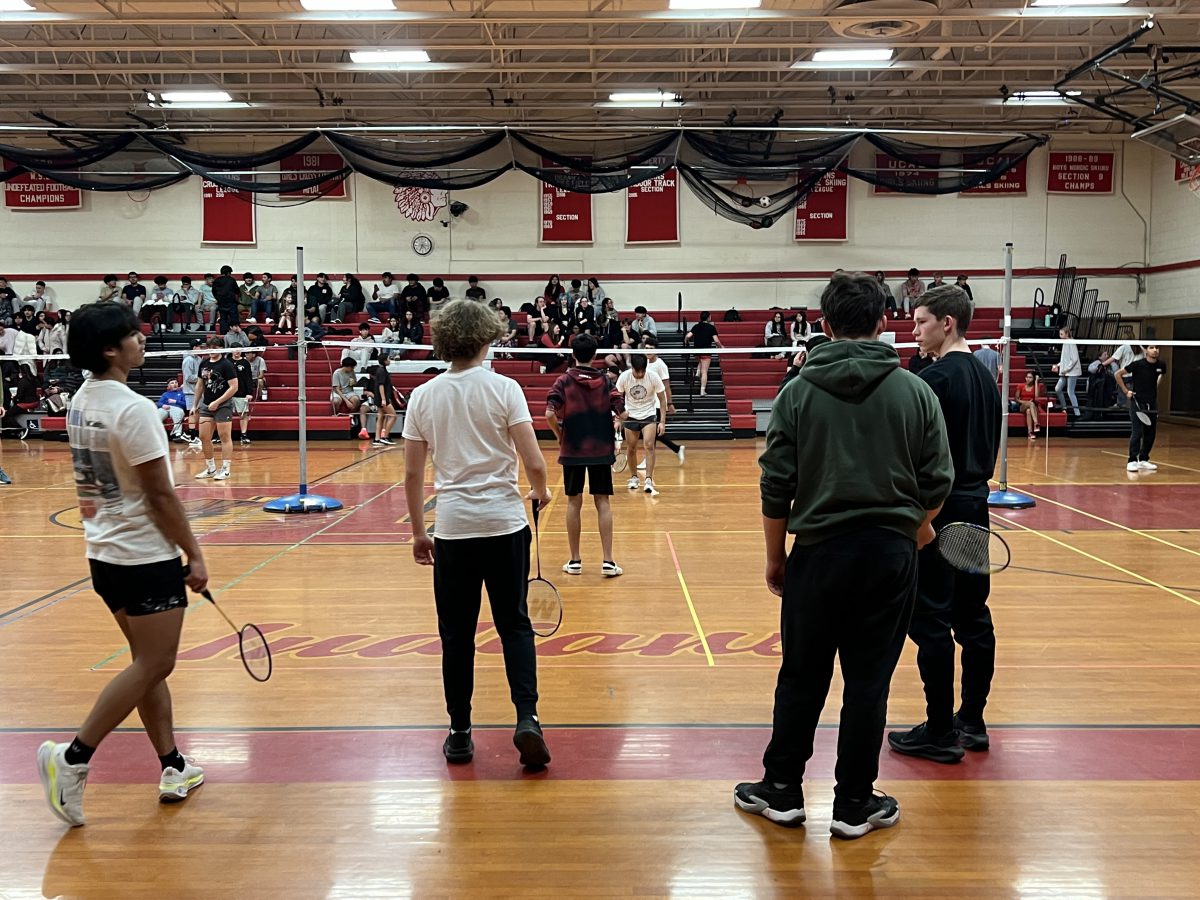 Student waiting their turn watch a badminton match