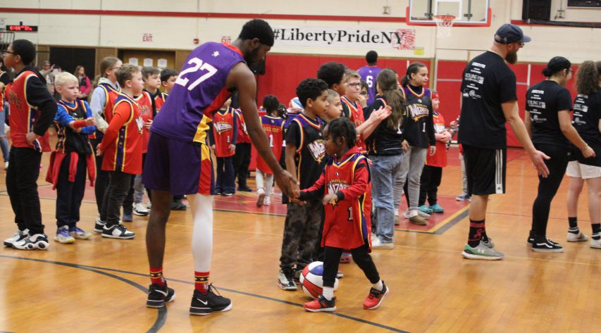 A young student slaps the hand of a Wizards player