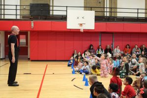 students point as a magician does a trick