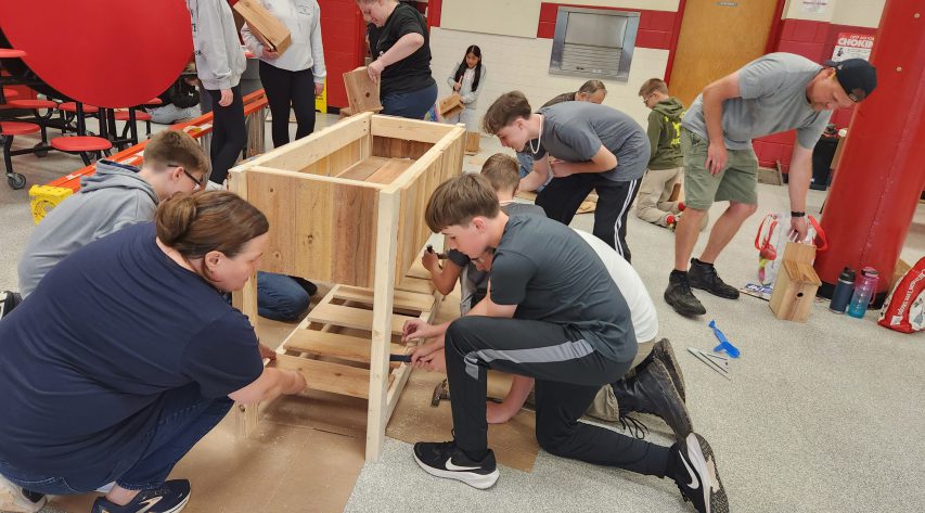 Students build a raised garden bed.