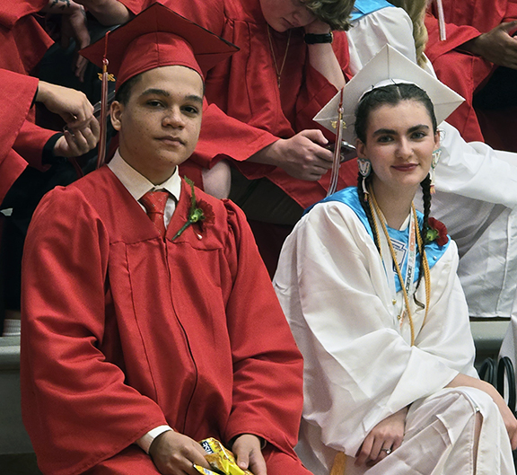 Two graduates pose for a photo