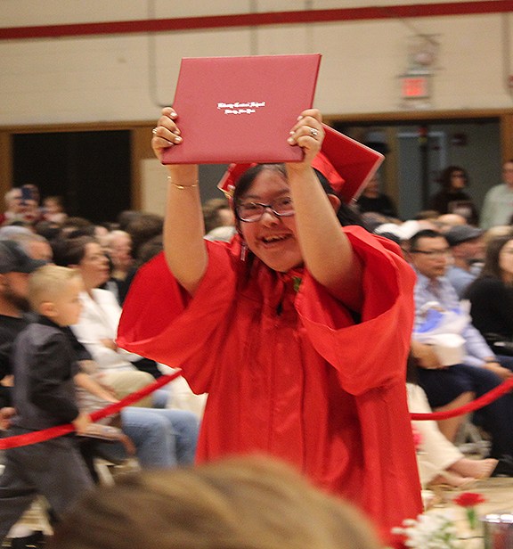 A student hold up her diploma