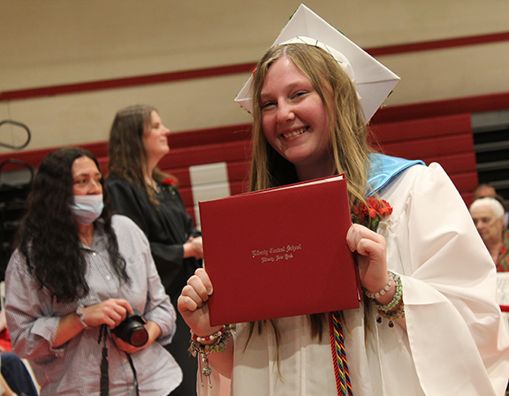 A student holds a diploma
