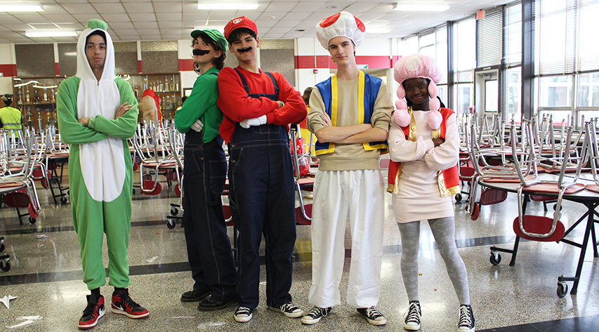 Five students pose as characters from Super Mario Bros.