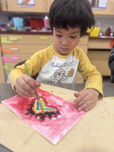 A student paints a heart