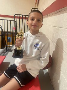 A student holds a trophy