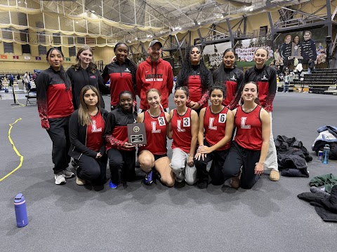 A track team poses with their coach