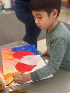 A student paints a heart