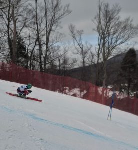 A skiier races down the moutain