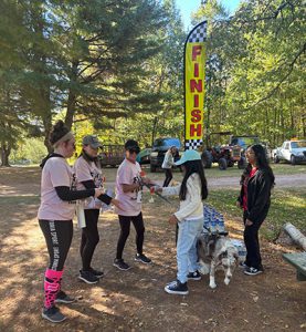 Student give prizes for finishers of the 5k near a finish size.