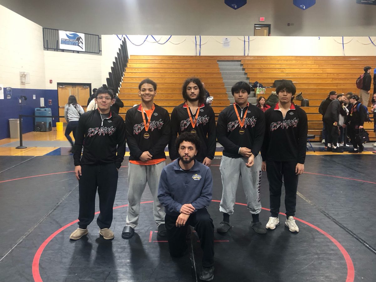 Members of the wrestling team pose with their coach