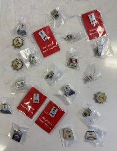 Olympic pins are displayed on a table