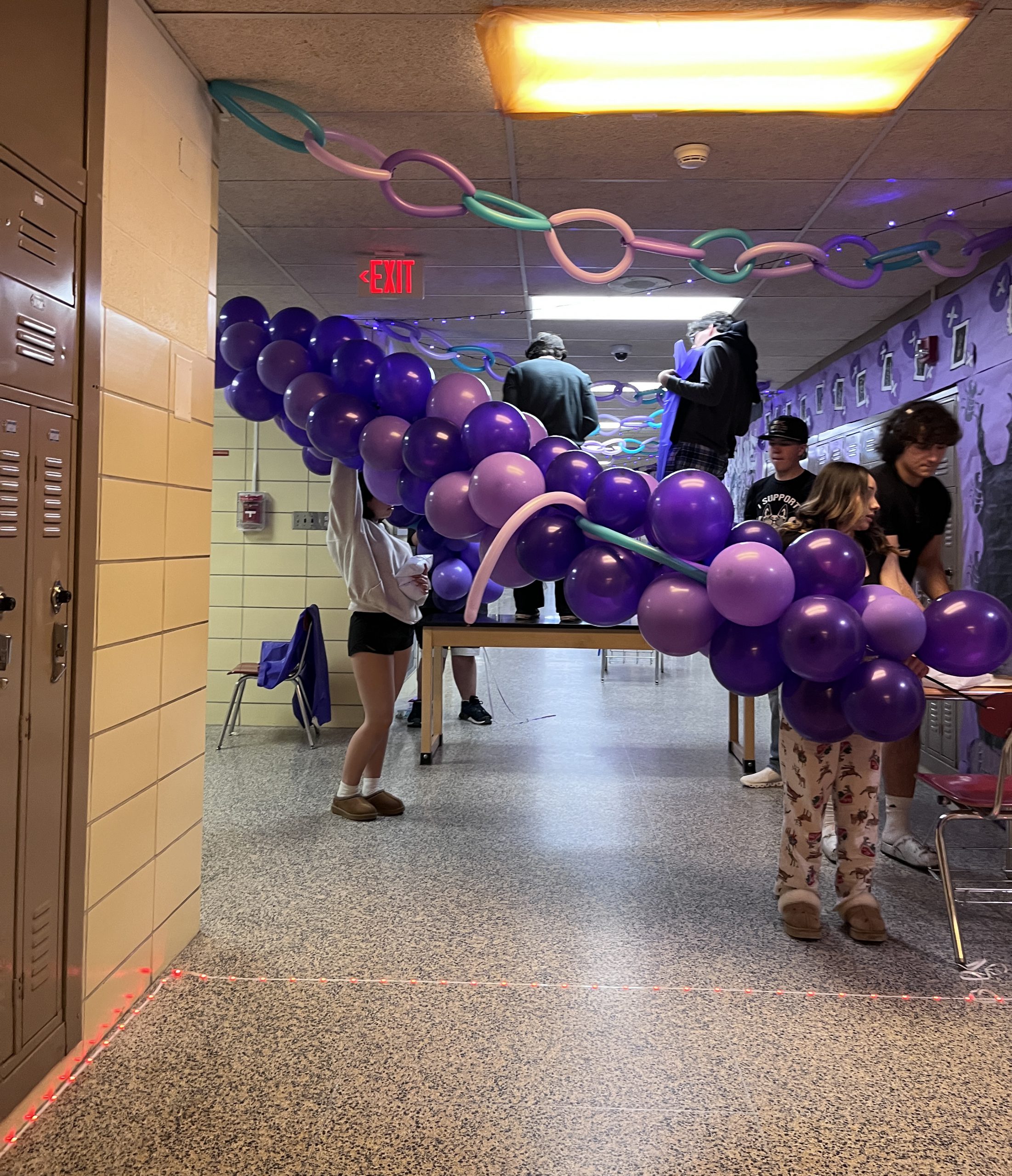 class of 2026-hallway-decorating Students decorate a hallway with purple balloons