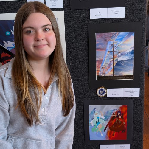 Allison A student poses next to her digital art
