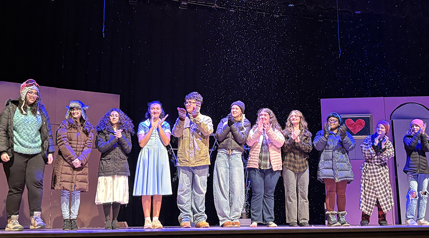Students clap during a curtain call