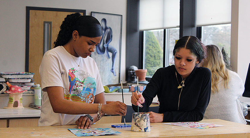 Two students work on paintings