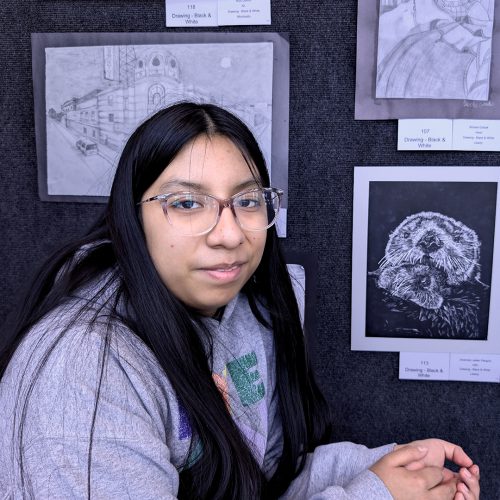 Jhosmery A student poses next to her black and white photo
