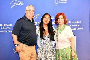 Three people pose for a photo in front of a blue backdrop with the Sullivan BOCES Career & Technical Education Center logo.