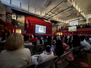 Students and staff watch a video