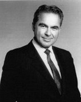 alan gerry, portrait, black and white image, wearing suit/tie, smiling facing camera, alumni of liberty and honoree of wall of fame