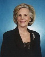 elaine grossinger etess, alumni of liberty and honoree of wall of fame, blue background, short blonde hair, smiling woman