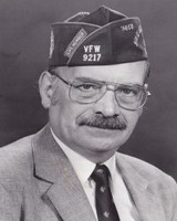 jack simons, alumni of liberty and honoree of wall of fame, wearing a vfw hat, glasses, suit and tie. black and white photo, smiling with mustache