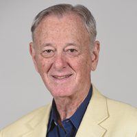 melvin urofsky, alumni of liberty and honoree of wall of fame, smiling, wearing white suit jacket and blue shirt